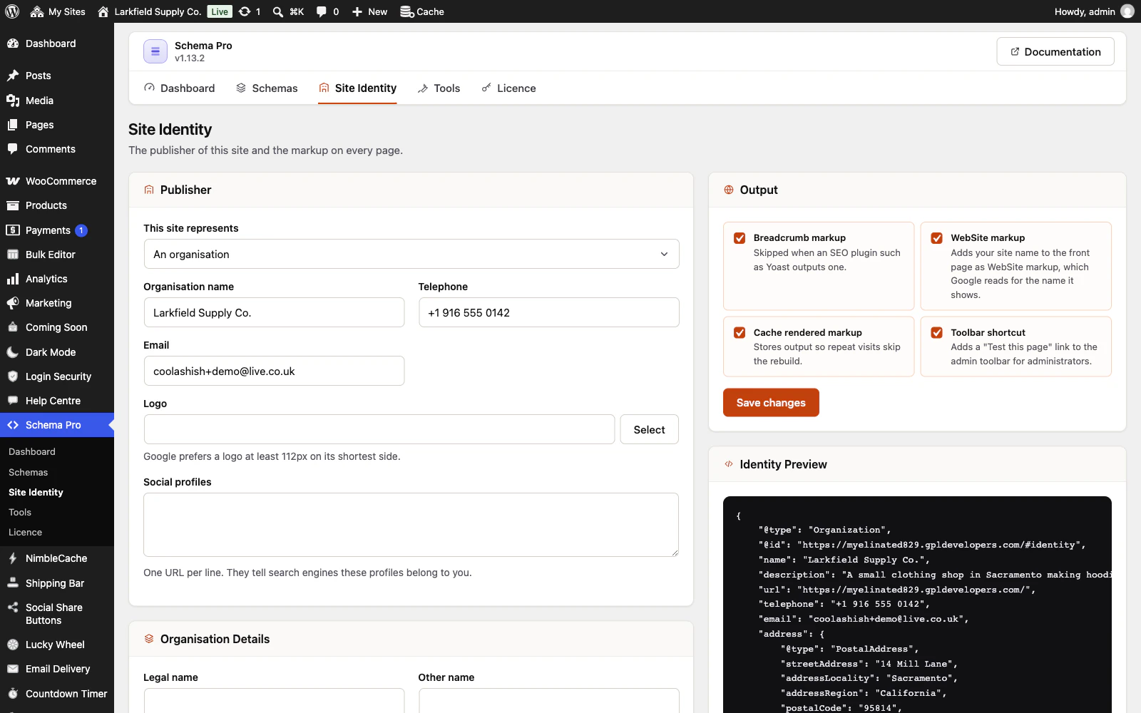 The Site Identity screen of Schema Pro. The Publisher panel says the site represents an organisation named Larkfield Supply Co., with a telephone number, an email address, a logo picker and a box for social profiles. On the right, Output switches for breadcrumb markup, WebSite markup, cached markup and a toolbar shortcut are ticked, and an Identity Preview shows the Organization JSON-LD with the shop's name, description, telephone, email and its address at 14 Mill Lane, Sacramento, California.